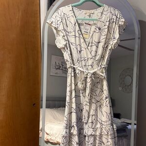 Chic White Wrap Midi Dress with Black Floral Design